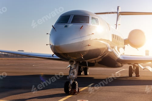Preview: Scenic front view modern luxury expensive private jet plane parked airport taxiway hangar warm