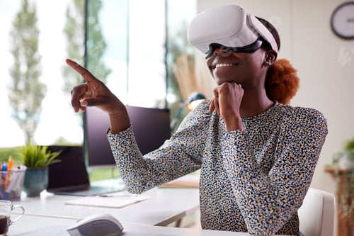 Preview: Woman Working From Home Office Sitting At Desk Wearing VR Headset Interacting With AR Technology