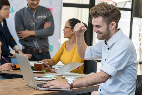 Preview: Businessman working in success action with computer over the photo blurred of Group Of Asian