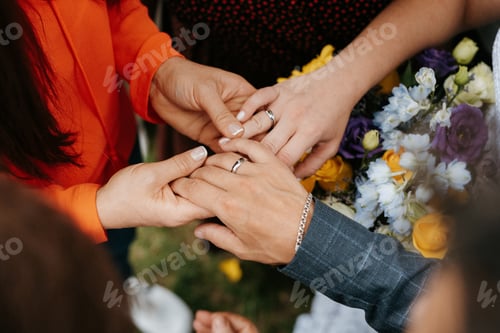 Preview: the bride and groom tenderly hold hands between them love and relationships