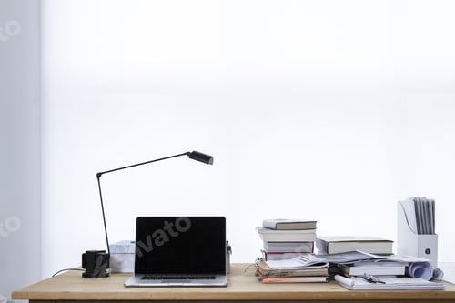 Preview: Work desk with a lamp, a laptop, books, and papers on it with a white background