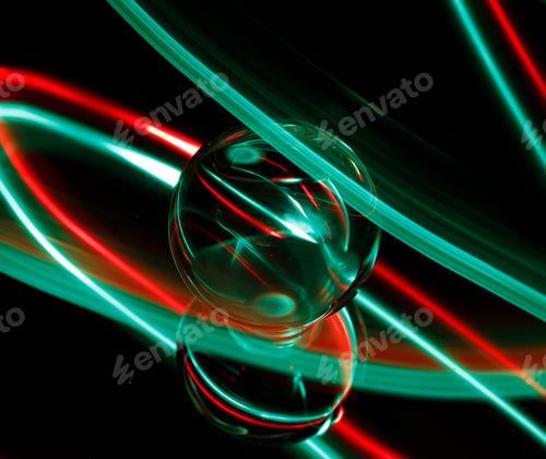 Preview: Intriguing green and red light emanating from a light bulb in a dimly lit setting
