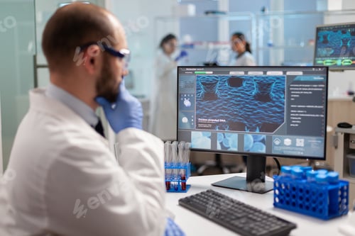 Preview: Thoughtfull doctor analyzing virus evolution on computer screen