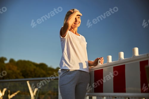 Preview: Beautiful joyful woman standing on the street