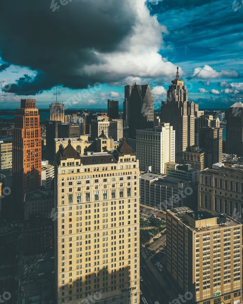 Preview: Vertical picture of buildings under a cloudy sky and sunlight in Detroit in Michigan, the USA