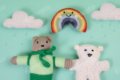Preview: Soft toys next to rainbows and thread clouds where it rains, toy world.