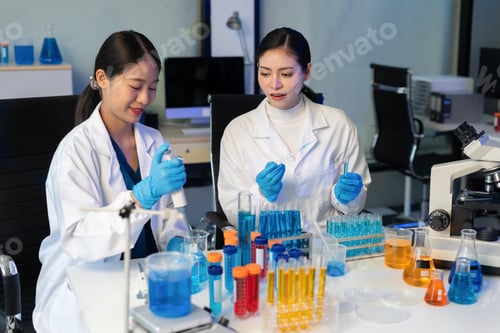 Preview: Scientist mixing chemical liquids in the chemistry lab.