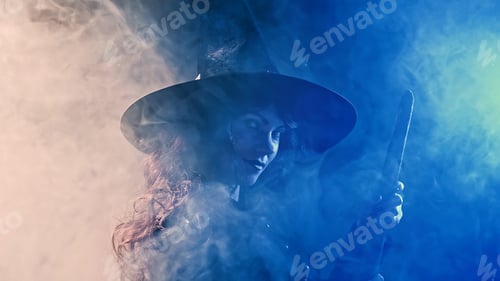 Preview: Classic witch flying on broom at misty blue sky at night. Halloween masquerade