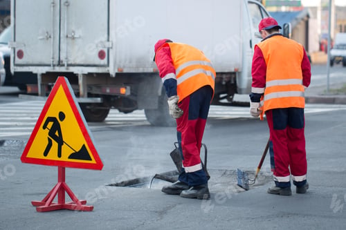 Preview: Young builder on Asphalting paver machine during Road street repairing works