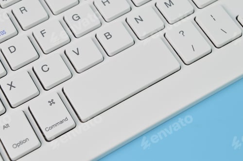 Preview: Close up view of computer keyboard isolated on a blue background. Copy space for the text