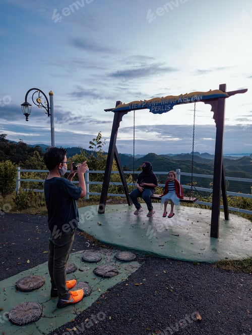 Preview: Perlis, Malaysia - August 6, 2022 Wang Kelian view point swing with tourists taking photo.
