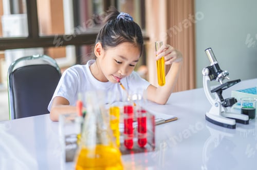 Preview: little scientist looking through a microscope and test tubes filled with chemicals