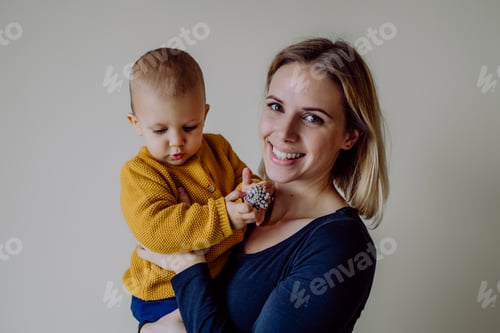 Preview: Happy young mother with little son looking at camera.