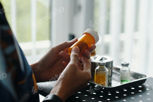 Preview: Hands Hold Prescription Medication Bottle Near Window