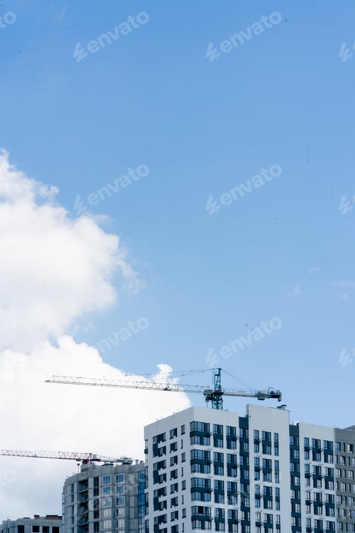 Preview: a urban landscape against the background of the summer sky high-rise new white houses construction