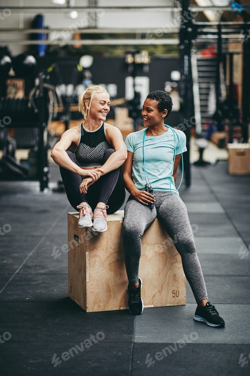 Preview: Fit young women laughing together after a gym workout