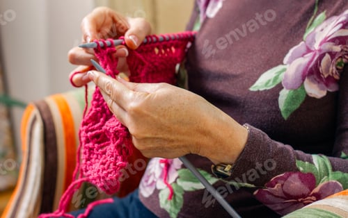 Preview: Hands of woman knitting a wool sweater