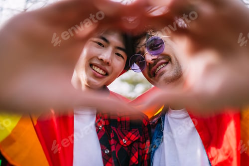 Preview: Close-up View of Gay Couple Forming a Heart Shape with Their Fingers