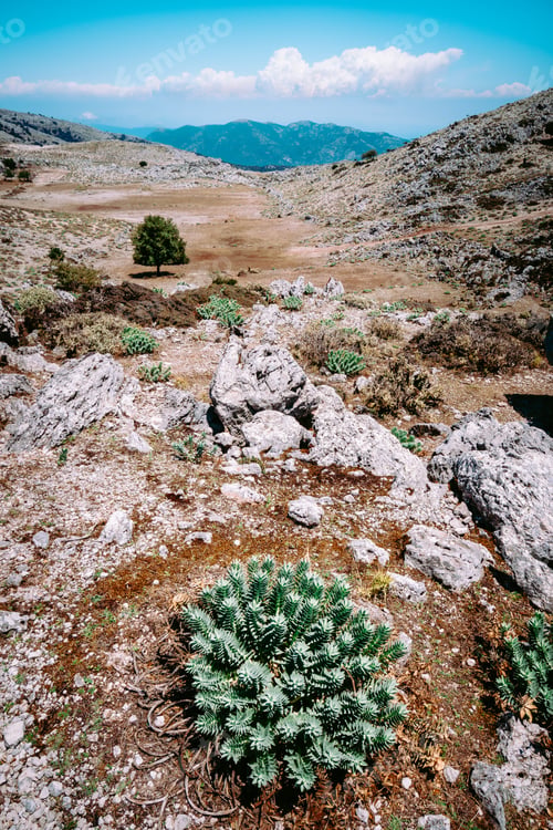 Preview: Amazing mountainscape plateau with motion clouds scenery on the horizon. Rocky highland in Greece