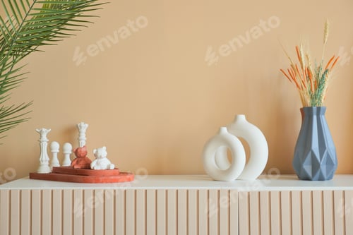 Preview: home interior decoration against light orange color wall .
