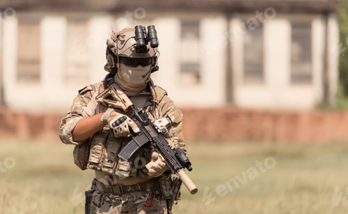 Preview: Special forces soldier in camouflage with a pair of weapons that are full of modern technology