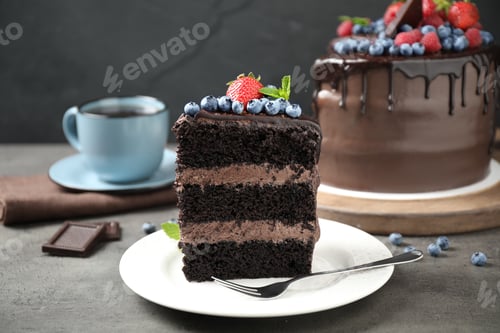 Preview: Piece of delicious chocolate cake decorated with fresh berries on grey table