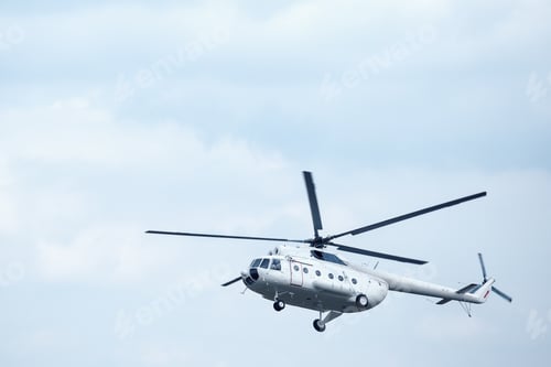 Preview: White helicopter in the blue sky