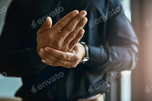Preview: Closeup shot of an unidentifiable businessman suffering with pain in his hands