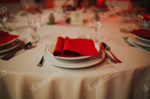 Preview: Closeup shot of an elegant table with red napkin decorations