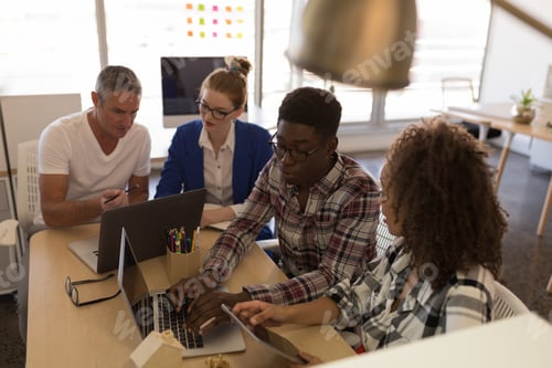 Preview: High view of diverse business colleagues working together in modern office. They work hard