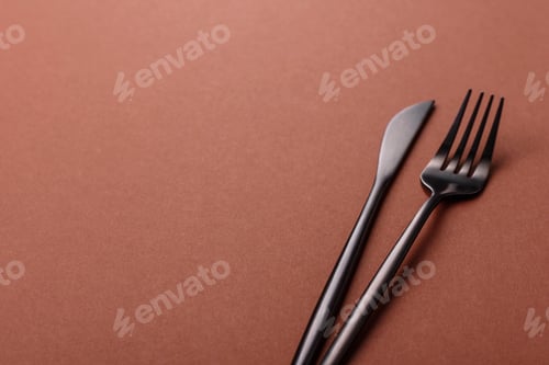 Preview: Knife and fork, cutlery on a brown dining table