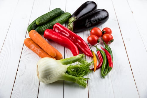 Preview: different fresh seasonal vegetables on white wooden table background