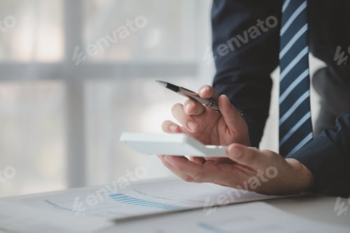 Preview: Businessman in a private office at his company and is reviewing company financial documents, senior