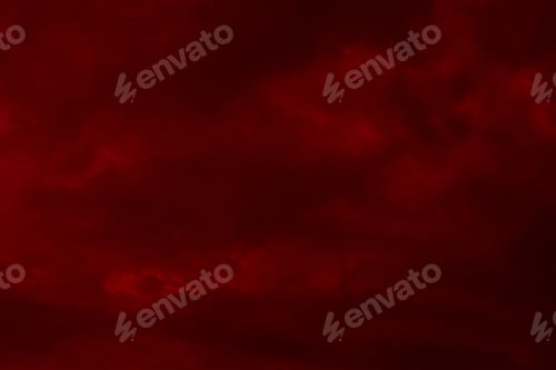 Preview: Red cloudy night sky background. Blurred photo of dark red sky.