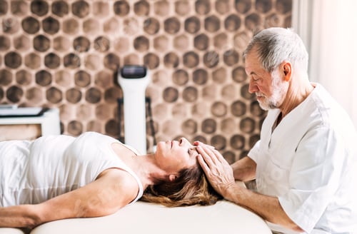 Preview: Senior physiotherapist working with a female patient.