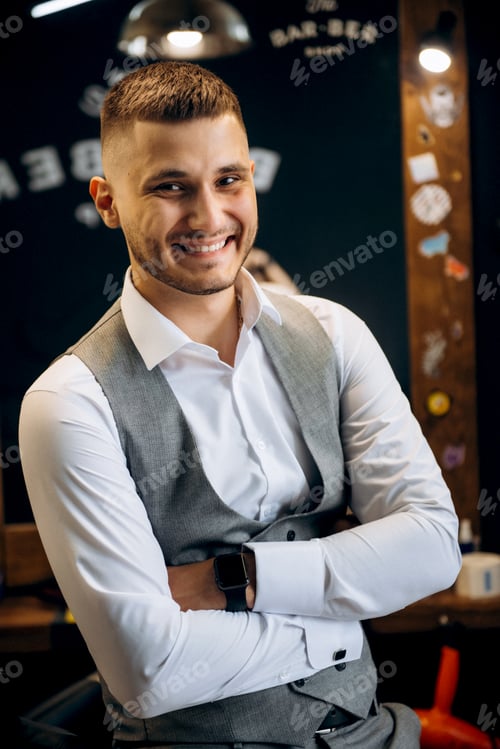 Preview: portrait of a young man getting ready at a barbershop