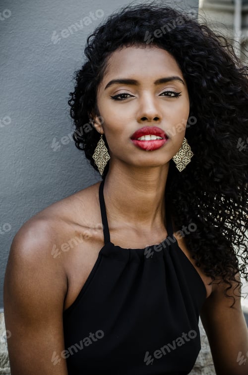 Preview: Black woman with red lips looking at camera