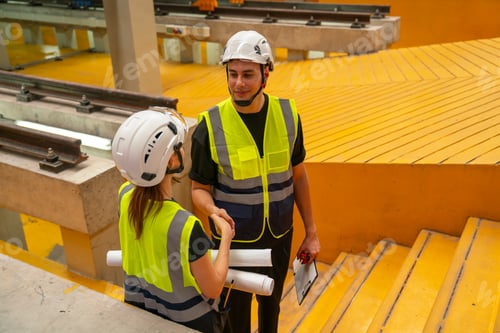 Preview: Two engineer or technician workers man and woman stand on step in area of factory workplace