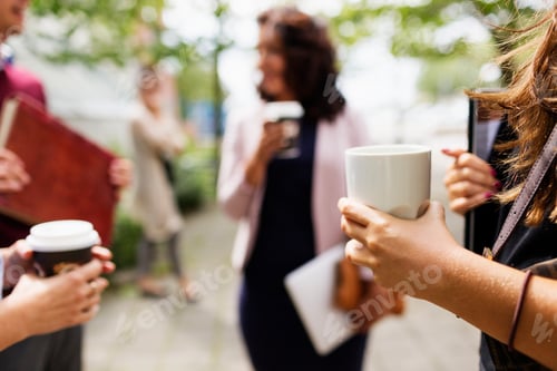 Preview: Business people having coffee outdoors