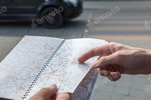 Preview: Male motorists studying a road map