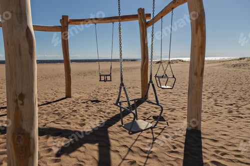 Preview: wooden natural children's ecological swing on beach by sea on sunny day