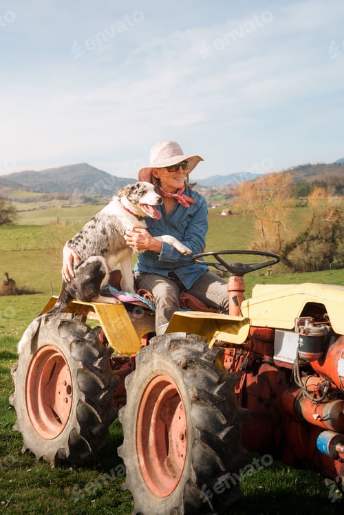 Preview: Woman with Dog Riding Tractor on Grassy Field