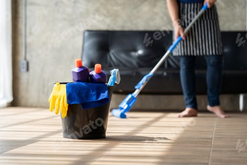 Preview: A young butler cleans the floor, mops the floor, carries a mop and a plastic bucket with brushes, gl