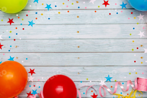 Preview: Colorful balloons and confetti on wooden table top view.