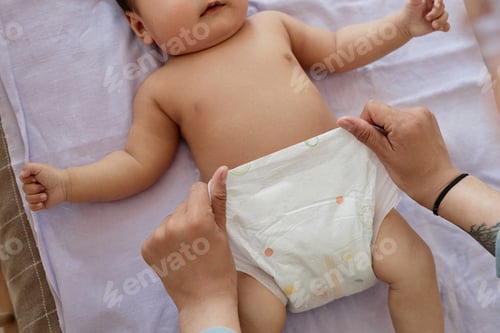 Preview: Mom putting diaper on the baby