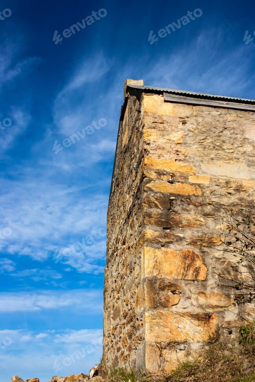 Preview: Low angle shot of an old house under a cloudy sky