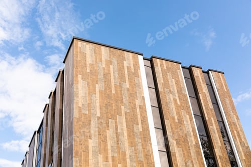 Preview: A large and tall gray house against the sky