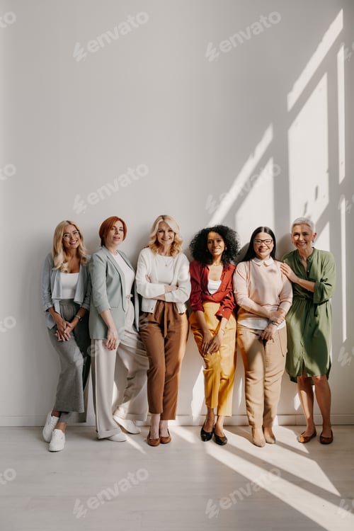 Preview: Group of beautiful mature women bonding and smiling while leaning on the wall together