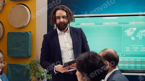 Preview: Project manager welcoming his team in business meeting