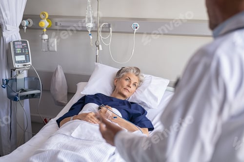 Preview: Senior patient listening to doctor at hospital